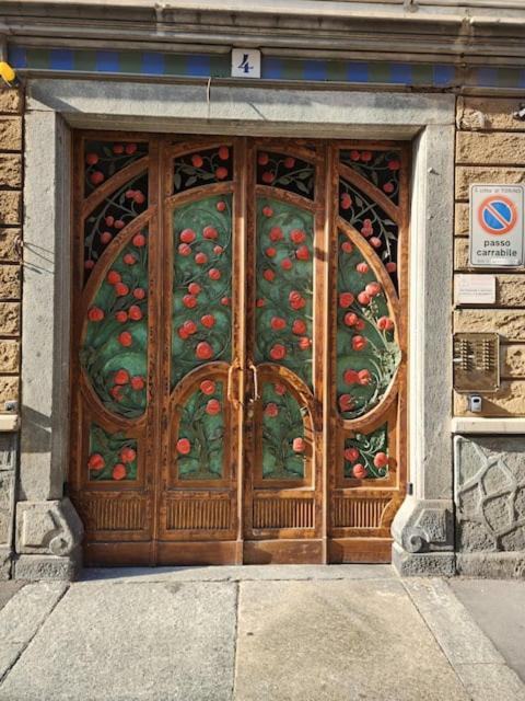 a wooden door with cherries on it on a building at La home del melograno in Turin