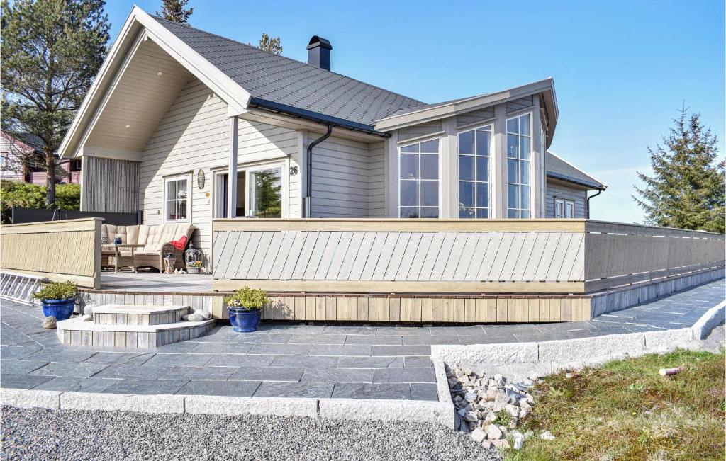 a home with a patio and a house at Gorgeous Home In Torangsvåg With Wifi in Skår