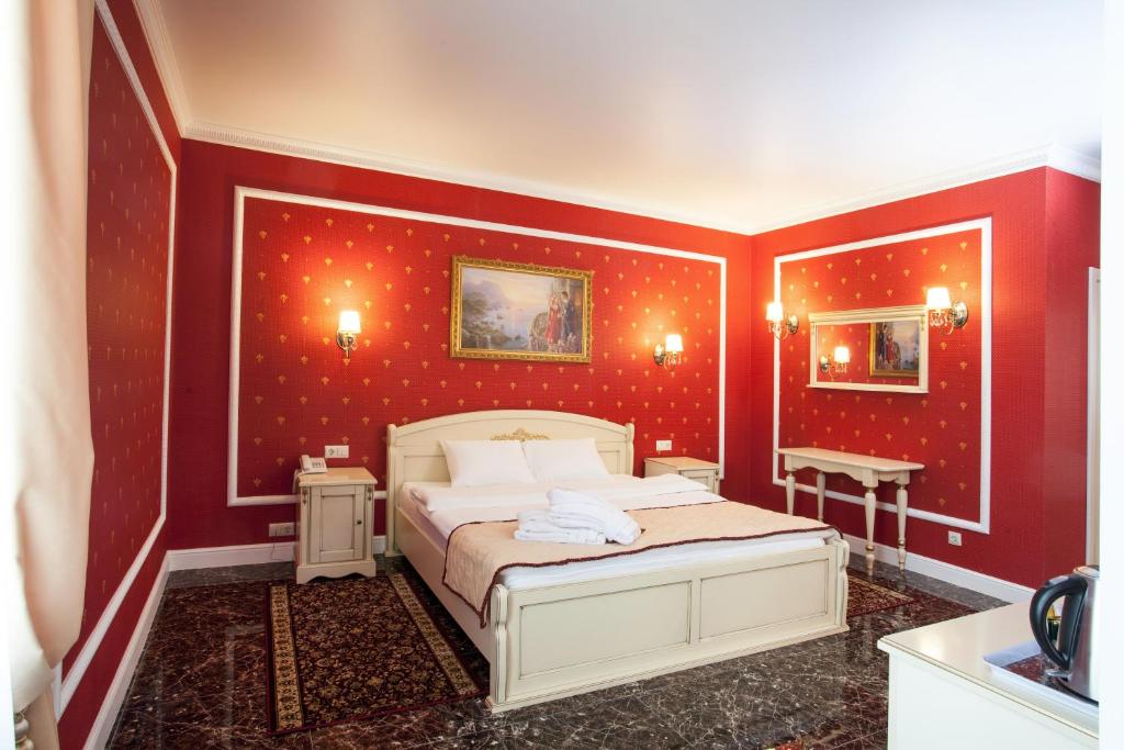 a bedroom with red walls with a bed in it at Chapaev in Voronezh