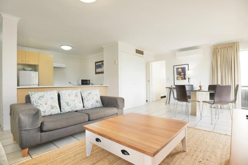 a living room with a couch and a table at Beach Lovers Dream 2BR in Noosa Heads