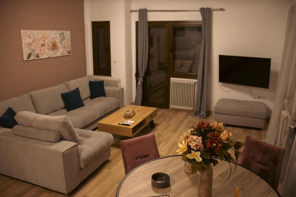 a living room with a couch and a table at Emily Apartment 5 in Chrysoupolis