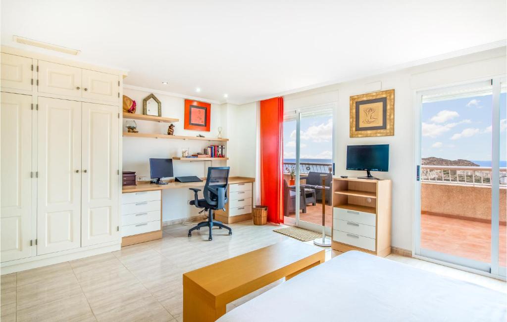 A television and/or entertainment centre at Stunning Apartment In Águilas With Wifi