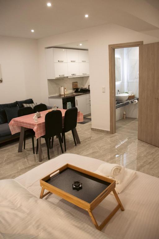 a living room with a table and a dining room at Emily Apartments 3 in Chrysoupolis