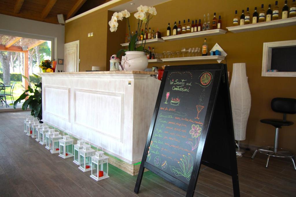 a bar with a sign in front of a counter at La Fattoria di Tirrenia in Tirrenia