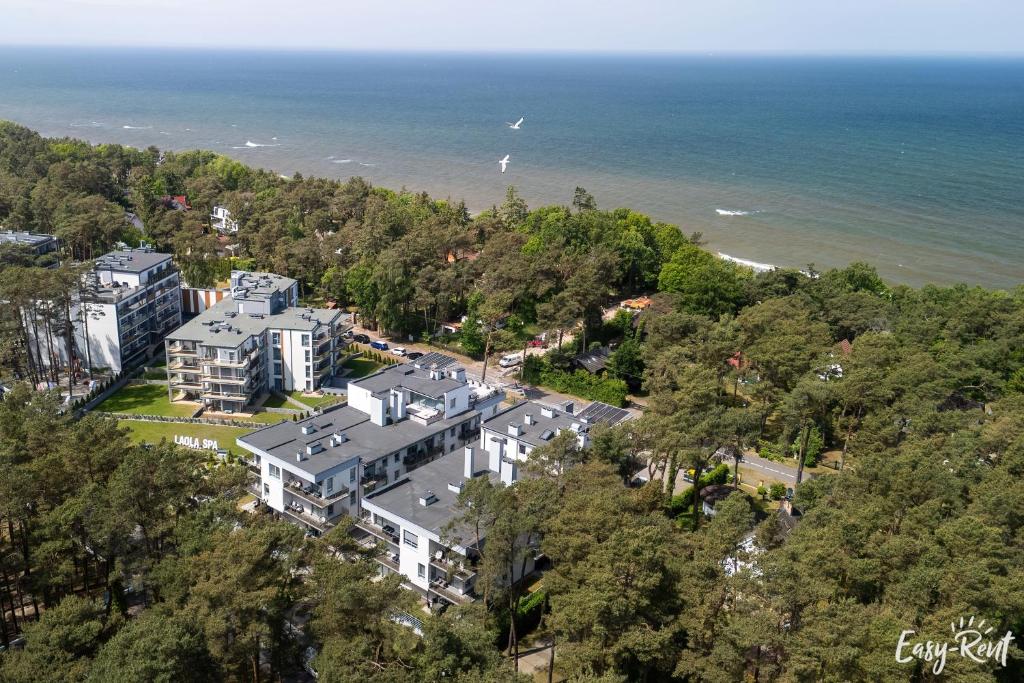 an aerial view of a large house next to the ocean at Apartament Doris 2 - 50 m do plaży in Pobierowo