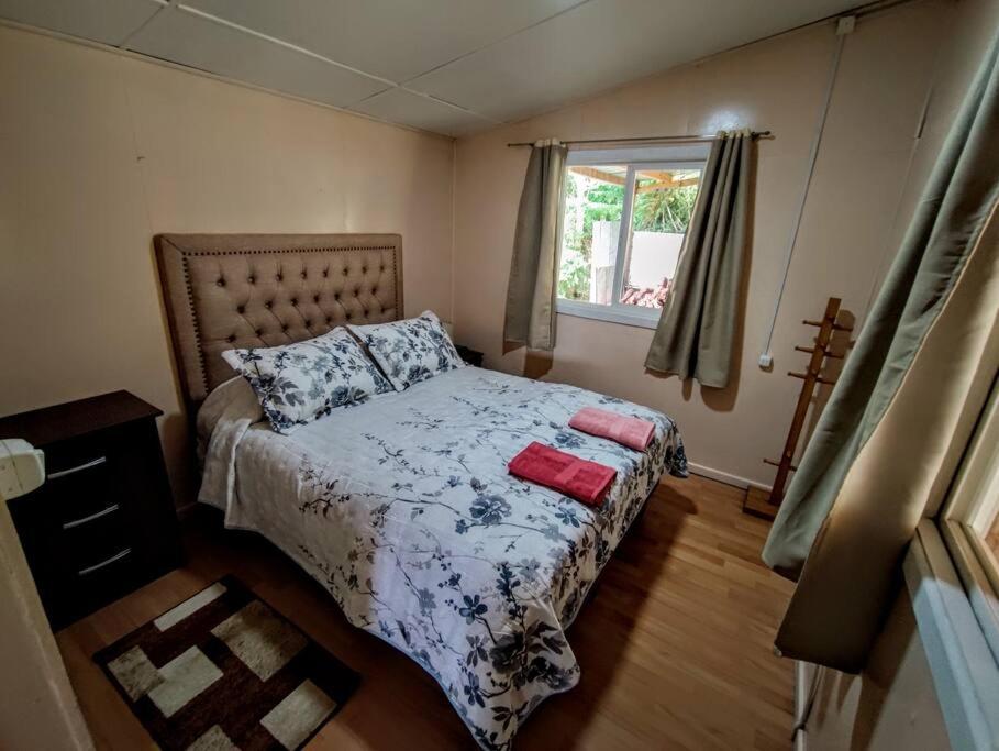 a small bedroom with a bed and a window at Casadelaisla-Rilan in Rilán