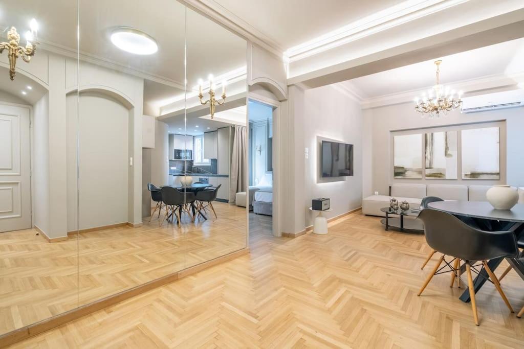 a living room with a table and a dining room at Urban Elegance in Kolonaki in Athens