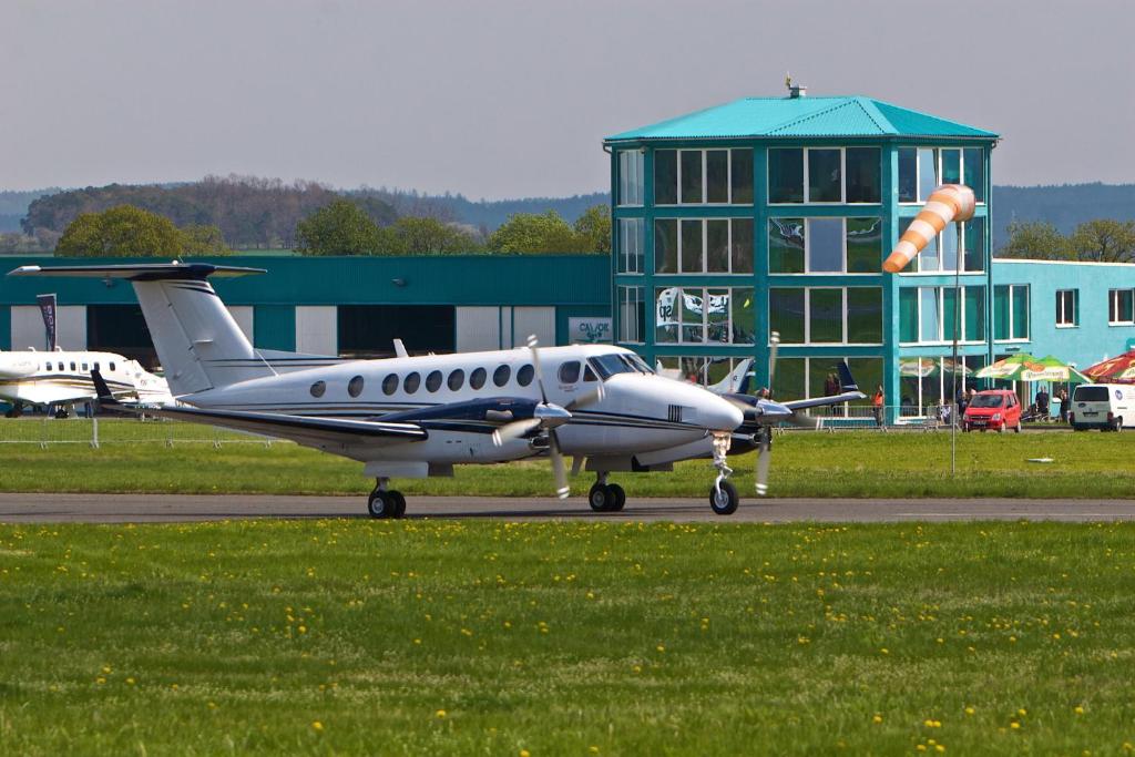 a small plane sitting on a runway in front of a building at Hotel CAVOK letiště Příbram in Drásov