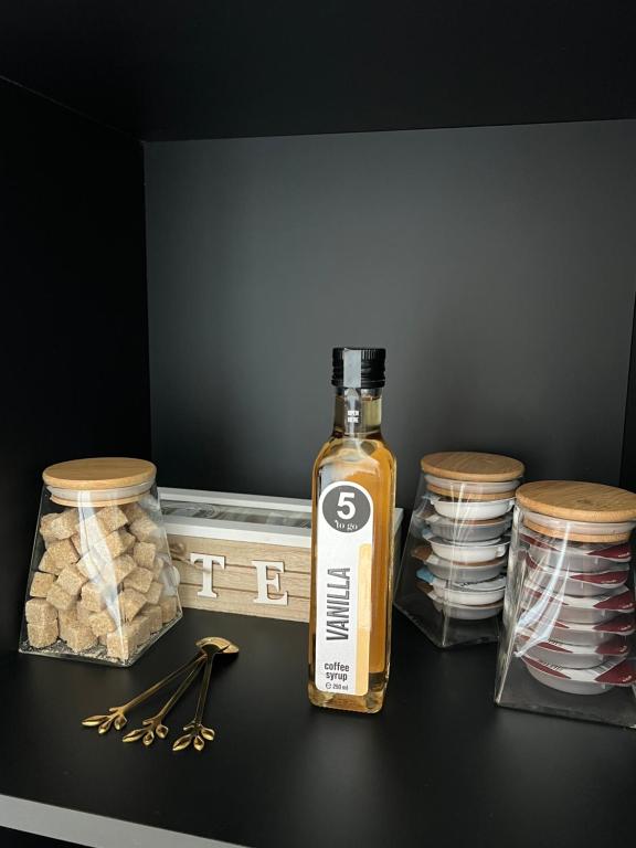 a bottle of alcohol sitting on top of a table at Elite Summer Suite in Năvodari