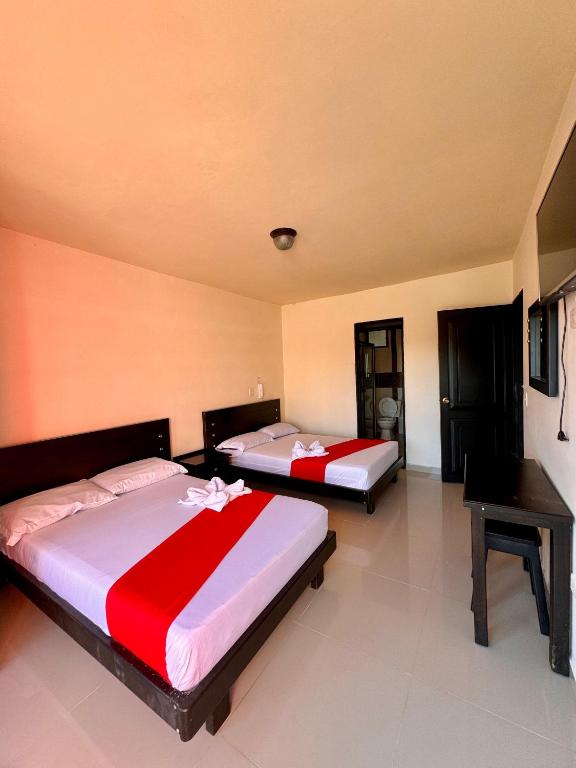 Postel nebo postele na pokoji v ubytování Hotel Portal Dorado