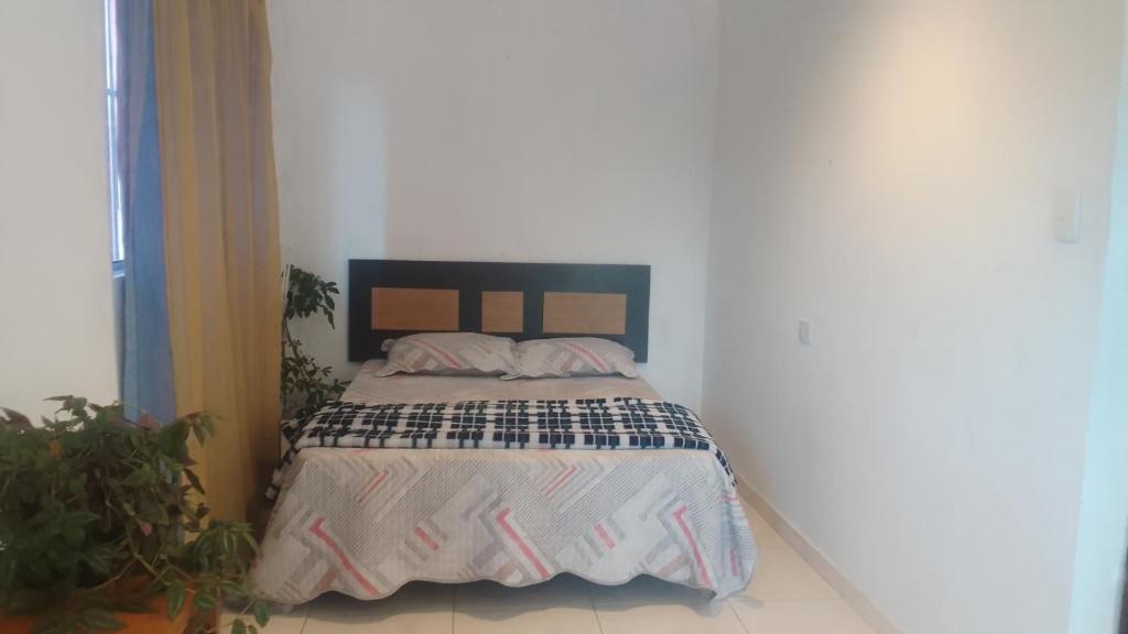 a bedroom with a bed with a black headboard at Casa na histórica - Santana de Parnaíba SP in Santana de Parnaíba