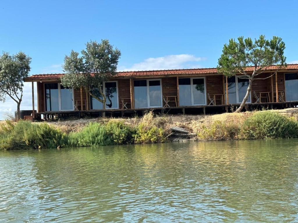 a house on the banks of a river at COMPORTA SIDE - Lake in Setúbal