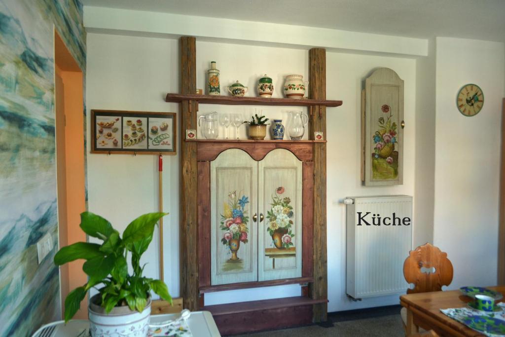 une pièce avec une armoire en bois sur laquelle sont peintes des fleurs dans l'établissement Im Herzen der Altstadt von Naumburg-Saale, à Naumbourg