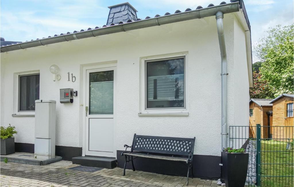 a white house with a bench in front of it at Lovely Home In Diemelsee Ot Sudeck in Rhenegge