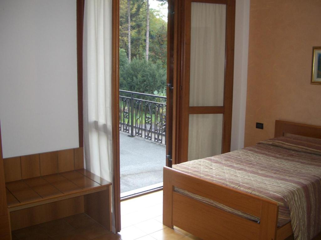 Postel nebo postele na pokoji v ubytování Albergo Il Castellino