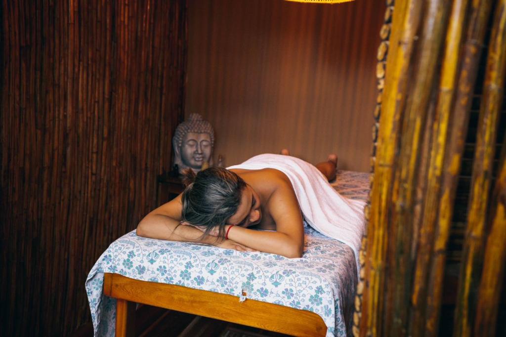 a woman sleeping on a bed in a room at Ekaa Hotel in Palomino