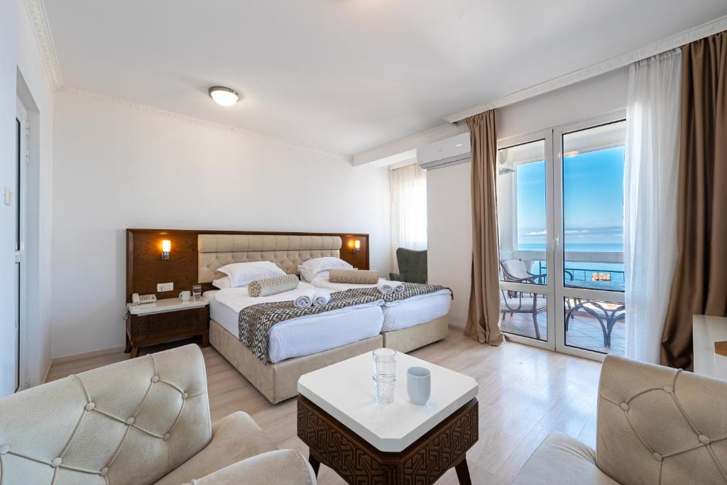 a hotel room with a bed and a balcony at Hotel Adrović in Sveti Stefan