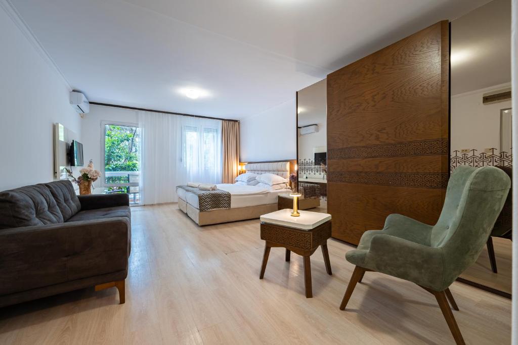 a living room with a couch and a bed at Hotel Adrović in Sveti Stefan