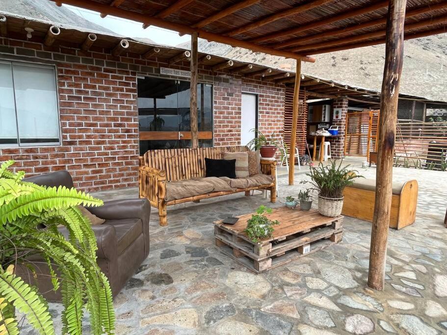 a patio with two couches and a table at Cabaña de Campo Huaral, hermosas vistas Piscina in Huaral
