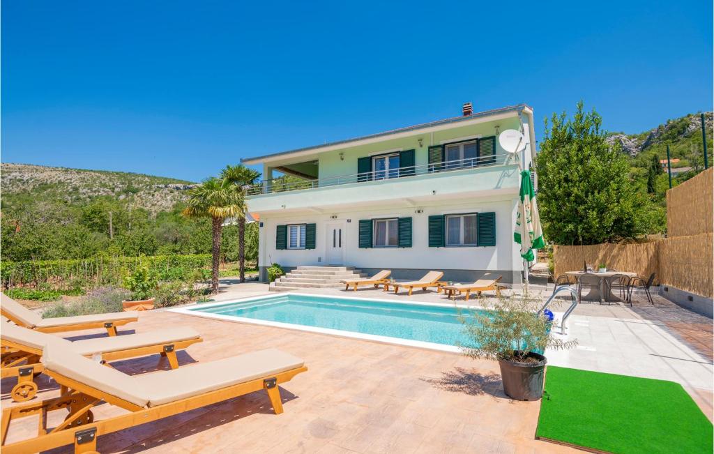 a villa with a swimming pool and a house at Three-Bedroom Apartment In Kresevo in Kreševo