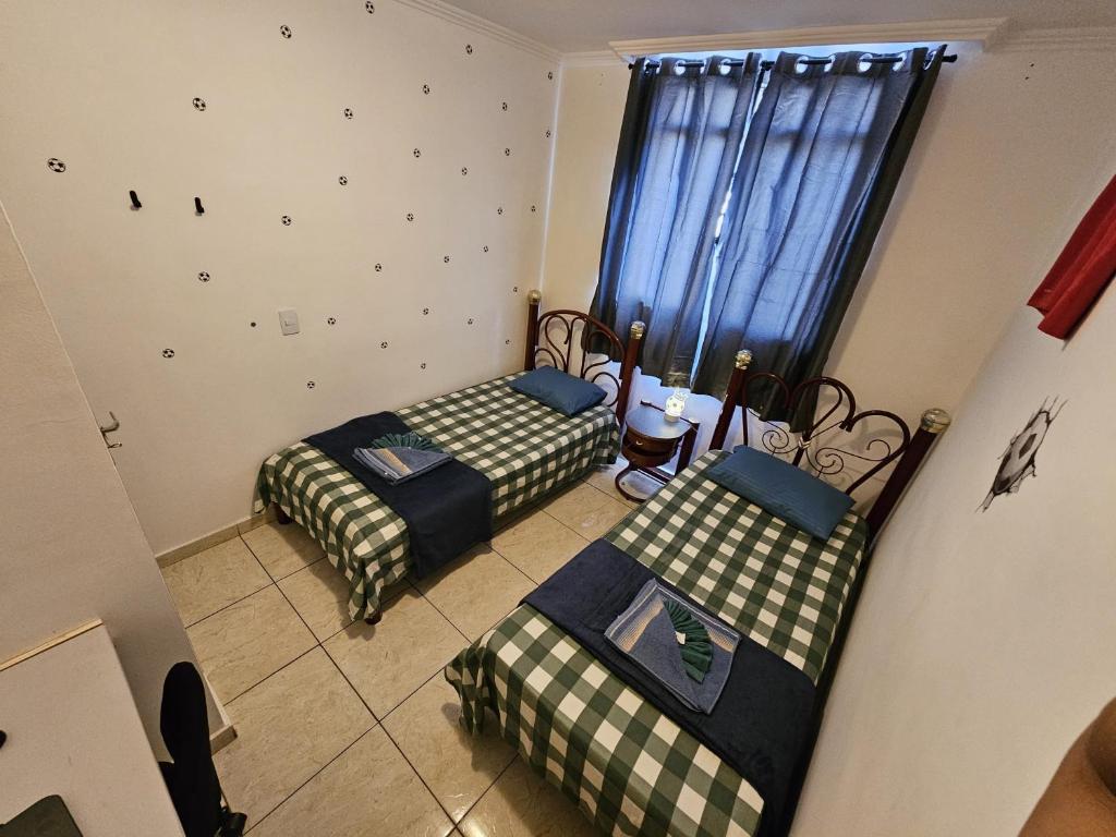 a room with two beds and a window at AP 3 quartos -2min da ARENA MRV e Expominas- BH in Belo Horizonte
