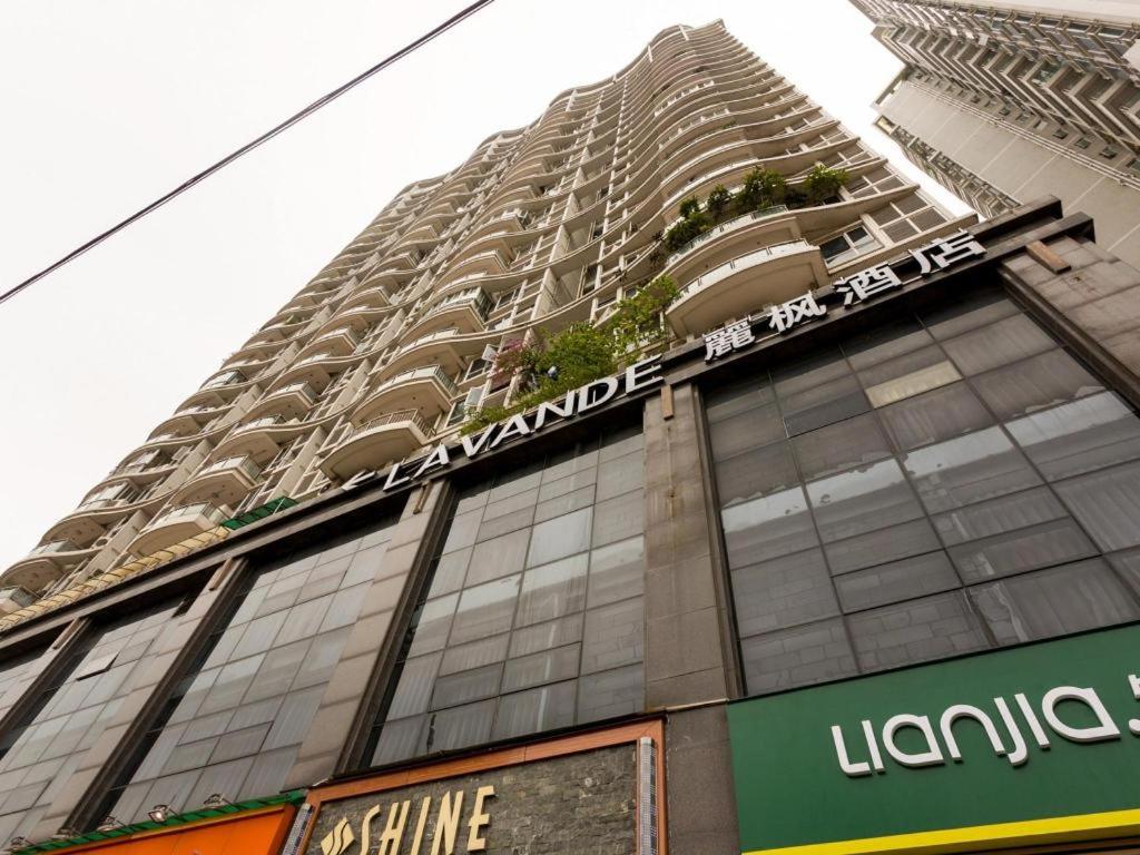 a tall building with a sign on the side of it at Lavande Hotel Guangzhou Tianhe Park Metro Station in Guangzhou