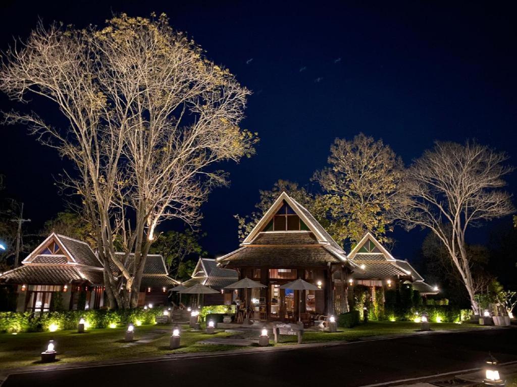 a resort with lights at night at Ruean Racha in Chiang Mai