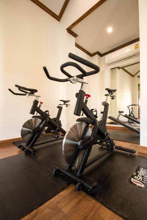 An indoor cycling room with stationary bikes and mirrored walls.