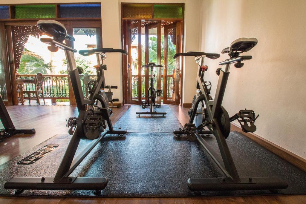A bright cycling studio opening toward a balcony or outdoor area.