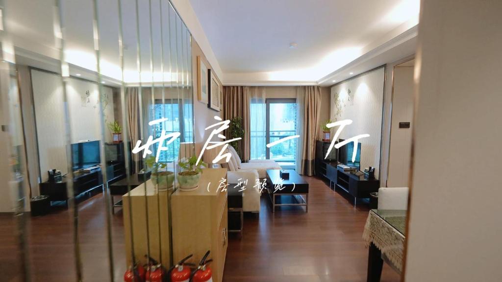 a living room with a couch and a table at Shenzhen Binhe Impression Hotel Apartments in Shenzhen