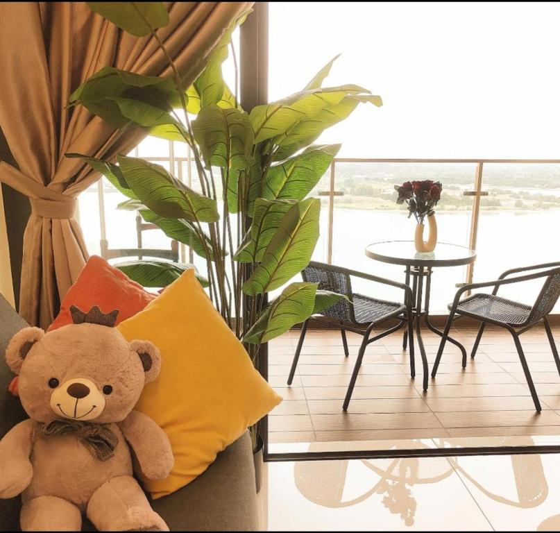 a teddy bear sitting on a couch in a living room at seaview beach4-13pax ksl CIQ midvalley johor bahru in Johor Bahru