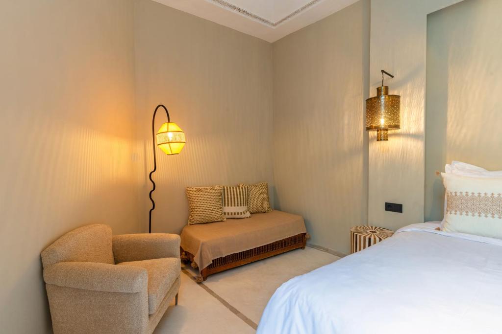 Postel nebo postele na pokoji v ubytování Suites & Spa BY XO-RIAD