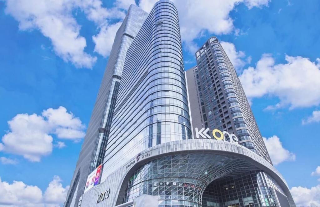 a tall building with a sign on the side of it at Shenzhen Binhe Impression Hotel Apartments in Shenzhen