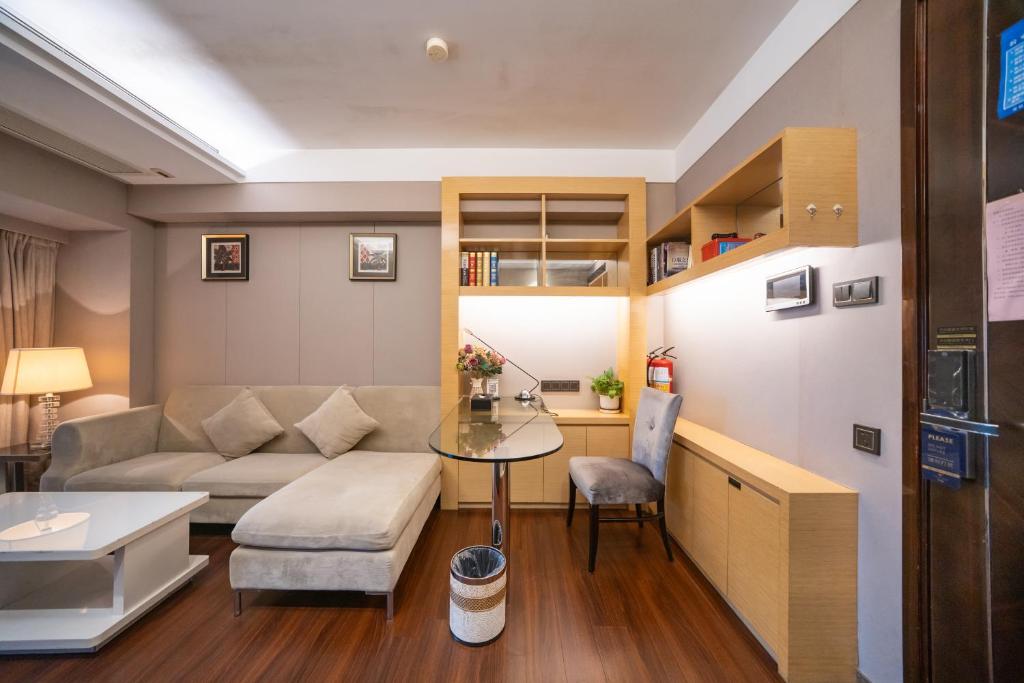 a living room with a couch and a table at Shenzhen Binhe Impression Hotel Apartments in Shenzhen
