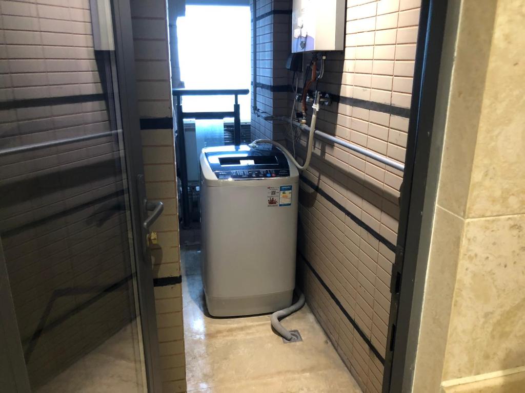 a hallway with a trash can in a room at Shenzhen Binhe Impression Hotel Apartments in Shenzhen