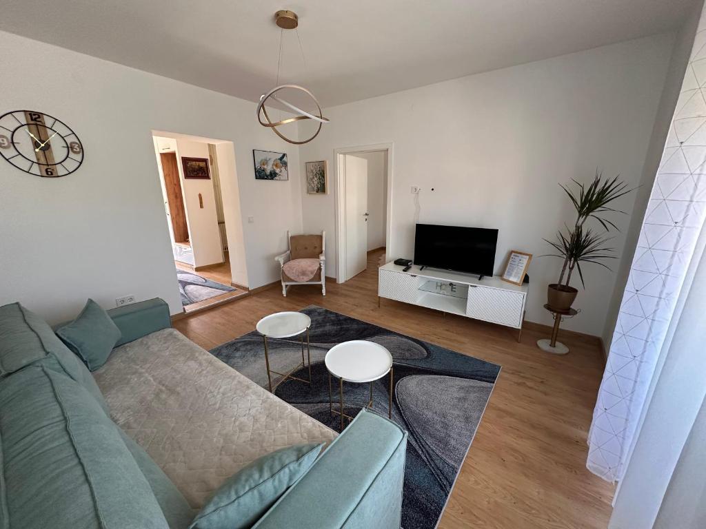 a living room with a couch and a tv at Darius in Tuzla