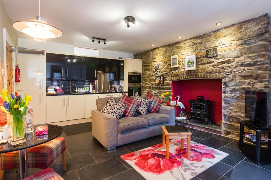 a living room with a couch and a fireplace at CWTCH APARTMENT by the sea in Aberystwyth