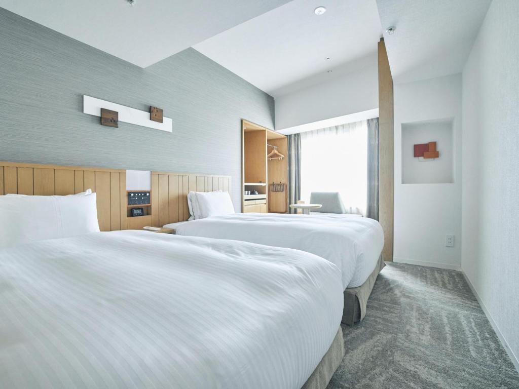 Letto o letti in una camera di Hotel Traveltine Kyoto Kiyamachi