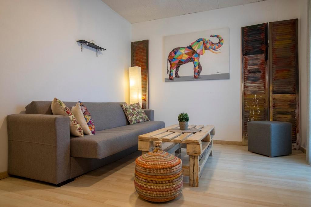 a living room with a couch and a table at Modern City Apt in the Heart of Heraklion in Heraklio Town