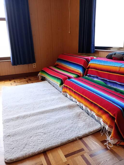 Postel nebo postele na pokoji v ubytování Sakurah