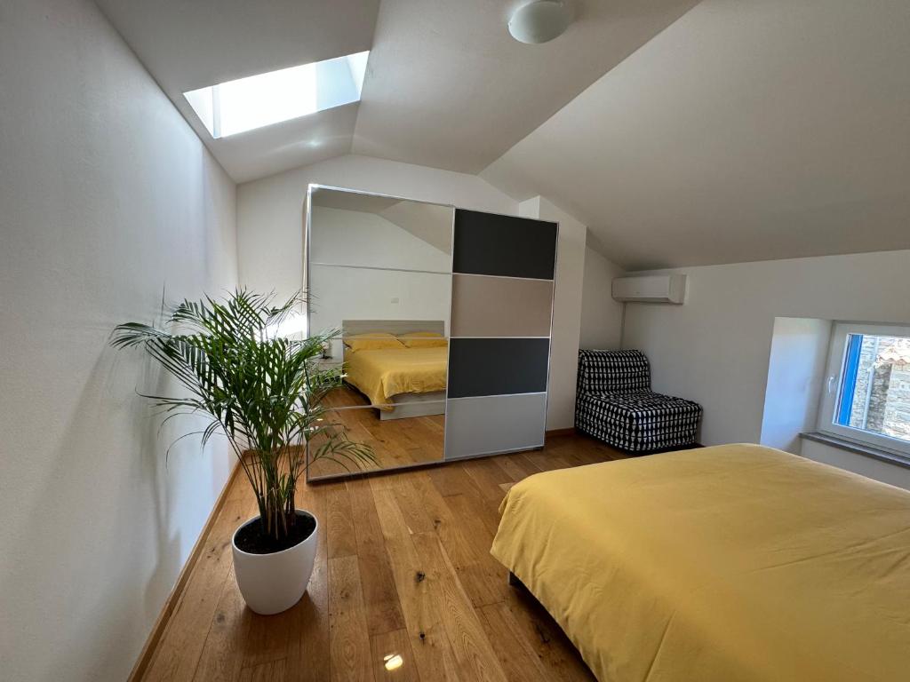 a bedroom with a bed and a large mirror at Santomas apartments in Šmarje