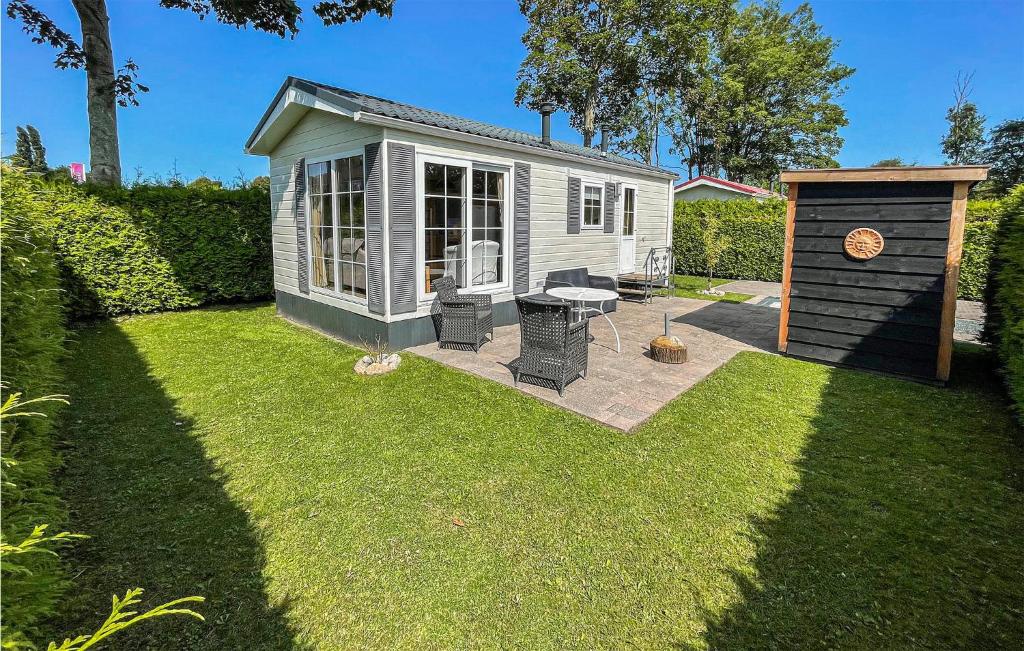 a small shed with a grill in a yard at Lovely Home In Tzummarum With Wifi in Tzummarum