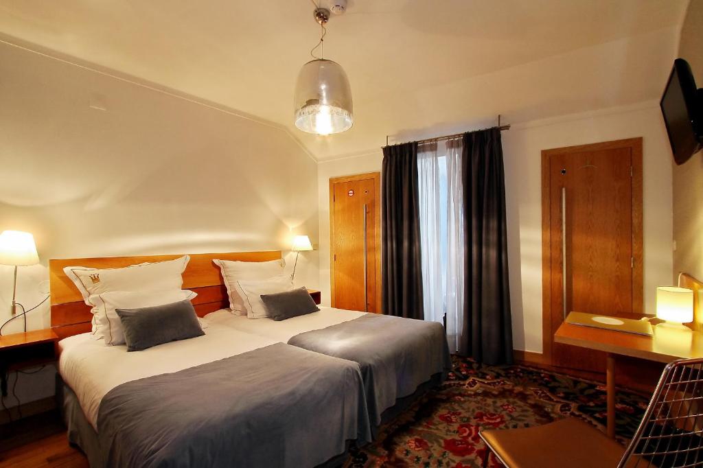 Postel nebo postele na pokoji v ubytování Hotel Mestre de Avis