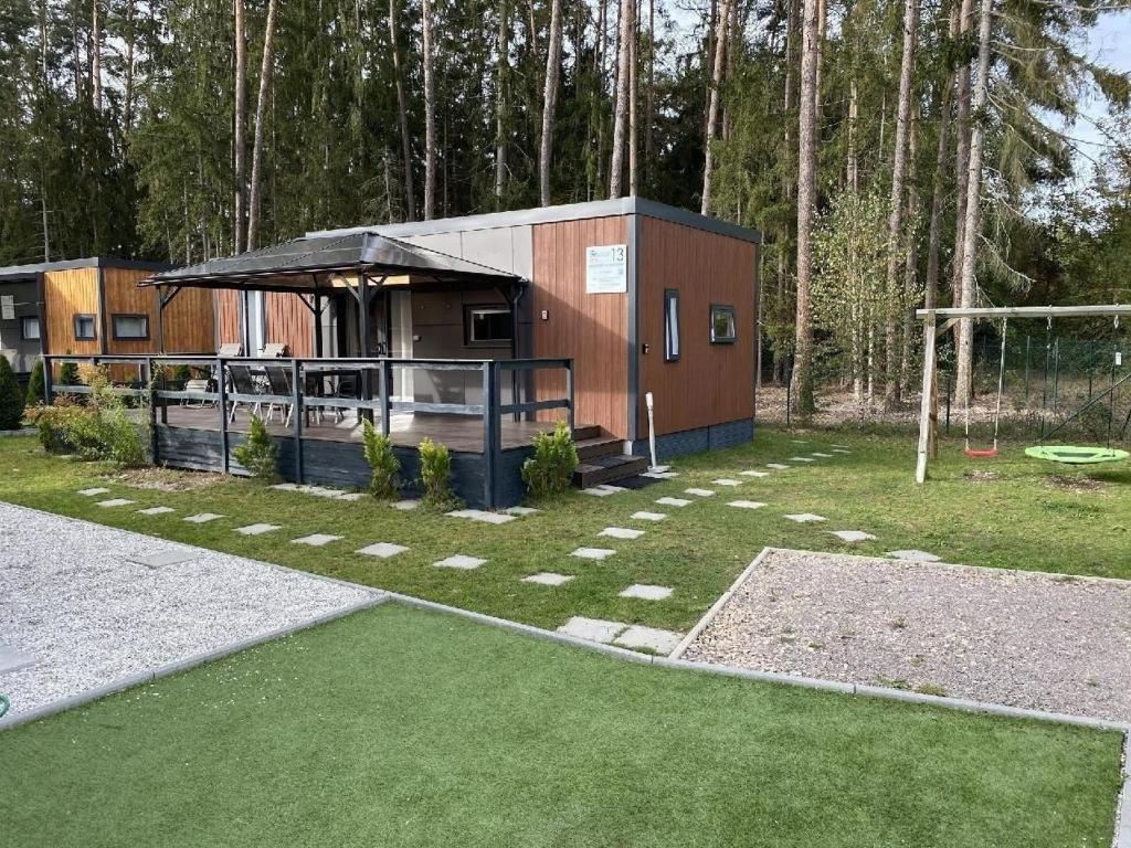 a small building with a soccer field and a goal at Ferienhaus in Wackersdorf mit Grill, Terrasse und Garten in Wackersdorf