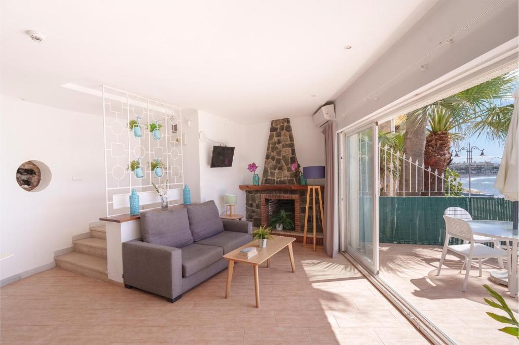 a living room with a couch and a table at Spirit Hotel Benalmadena Beach in Benalmádena