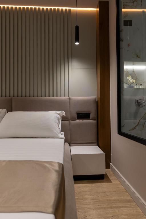 Postel nebo postele na pokoji v ubytování Grand Hotel Aita