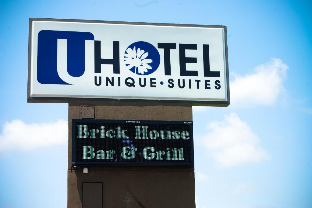 a sign for a uited unique services at Unique Suites Hotel in Charleston