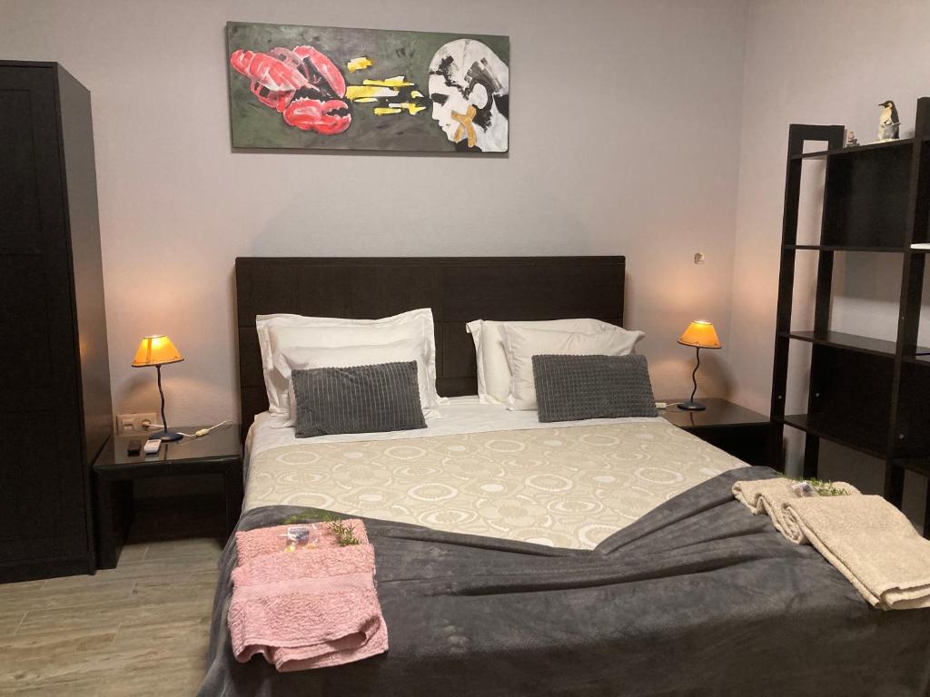 a bedroom with a large bed with two night stands at Yoga Farm in Tavira