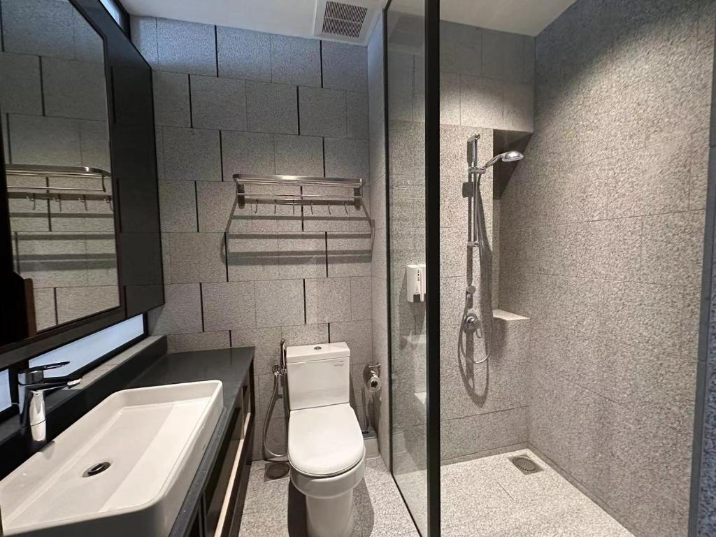 a bathroom with a toilet and a sink and a shower at Borderless Swimming Pool - Invincible Twin Towers View - Free WiFi in Kampong Gombak Utara