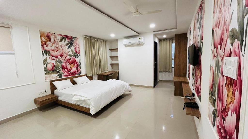 a bedroom with a bed and a painting on the wall at The Gamora in Gwalior